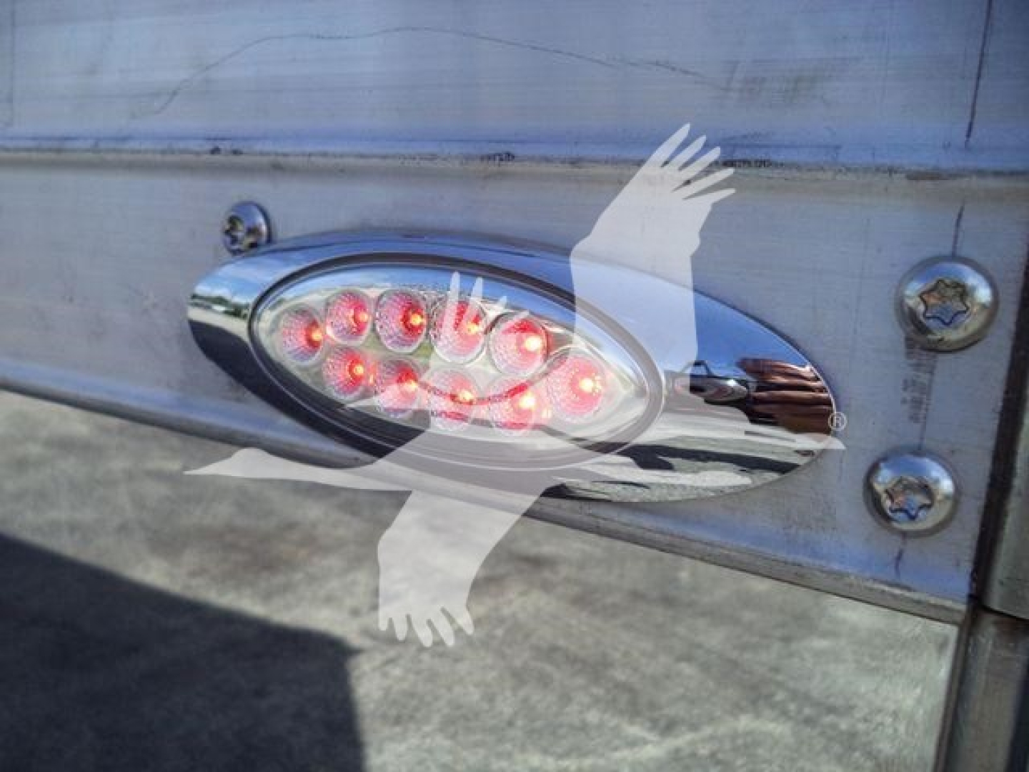 Truck tail light assembly on stainless steel back with stock text overlay in image
