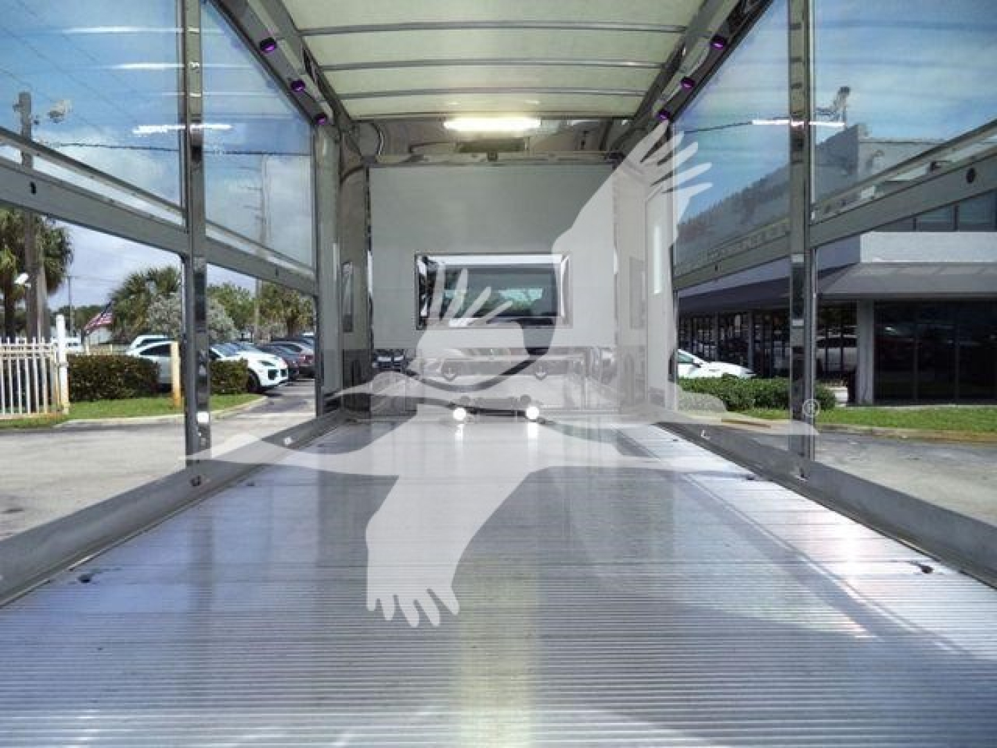MV Series truck bed interior view showing empty cargo area with metallic ribbed floor and side rails.