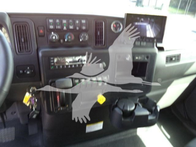Dashboard of a truck cab showing control panels, radio, climate controls, and a monitor on the right. Various switches and gauges visible.