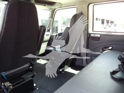 Interior of a new 2027 International MV rollback truck showing front seats, side doors, and rear seating area.