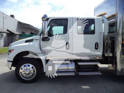 MV Series International rollback truck side view showing cab and chrome fuel tanks and steps with logo and text on door.