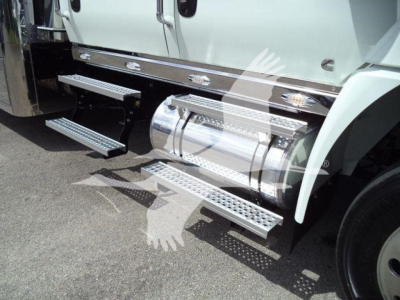 Truck side steps and fuel tanks on a white International MV truck showing chrome "+" running boards and dual tanks.