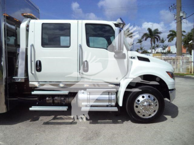 White 2027 International MV rollback truck side view showing cab and chrome steps