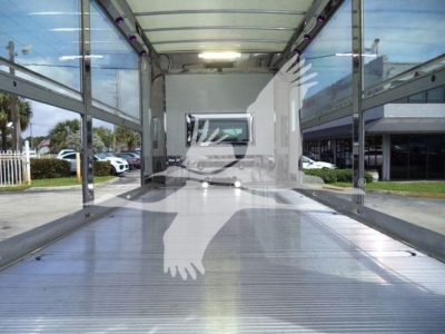 MV Series truck bed interior view showing empty cargo area with metallic ribbed floor and side rails.