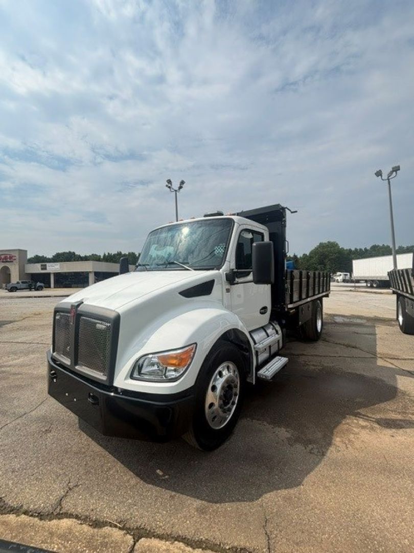 Kenworth T280 cab and chassis truck in a parking lot, white with black bumper, front grille, and dual rear wheels.