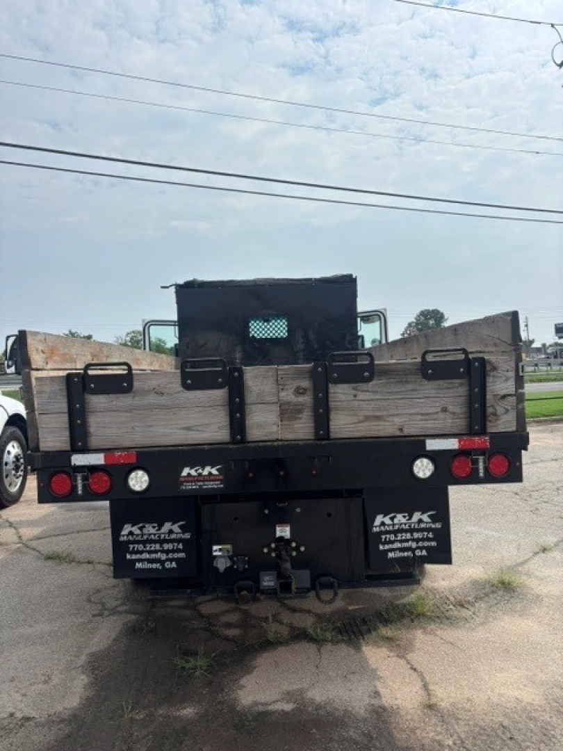 Kenworth T280 rear view showing cargo bed and bumper with company logos and contact numbers.