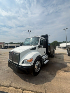 Kenworth T280 cab and chassis truck in a dealership lot, white exterior, black front bumper, metal dump bed, no visible damage.