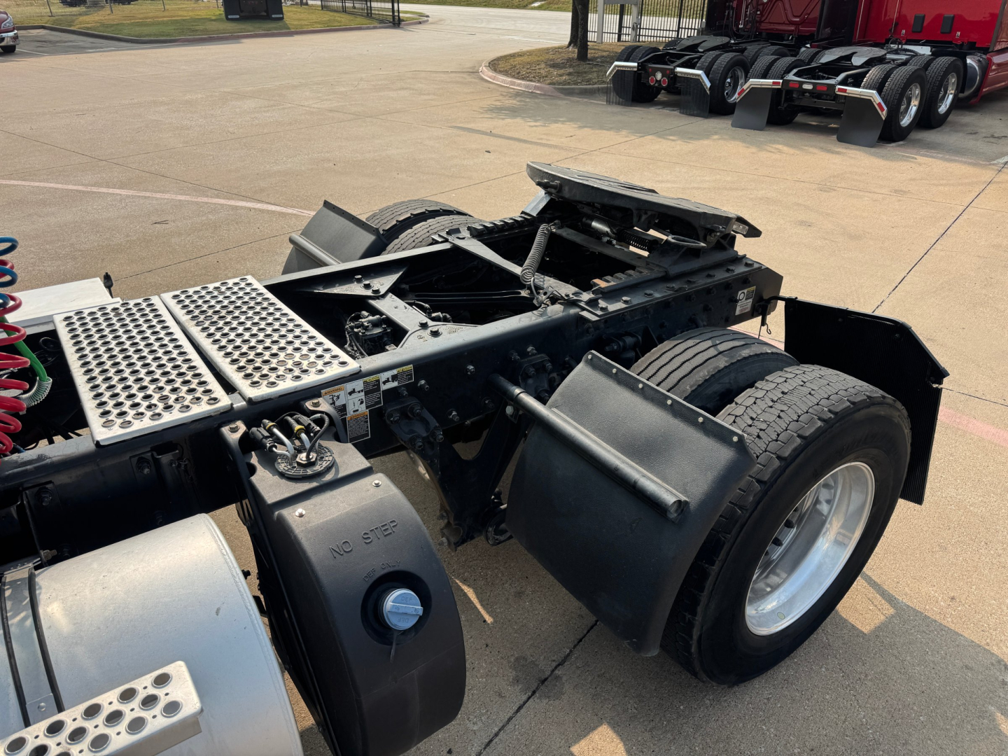 Kenworth T880 chassis with exposed frame and rear axles, showing fuel tanks, cabless tractor area, and wheel assemblies.