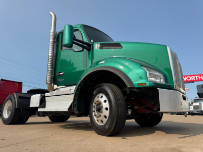 Kenworth T880 truck in green, front-left view showing cab, exhaust stack, front bumper and wheel.