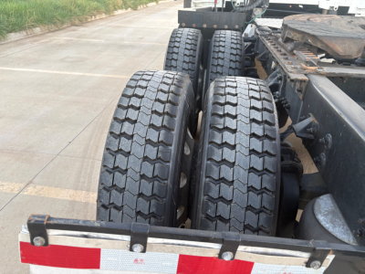 Kenworth truck chassis showing dual rear axles with heavy tread tires and partial frame; no visible text or labels readable on components.