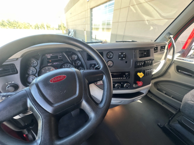 Peterbilt truck interior dashboard and steering wheel with instrument cluster and control panel.
