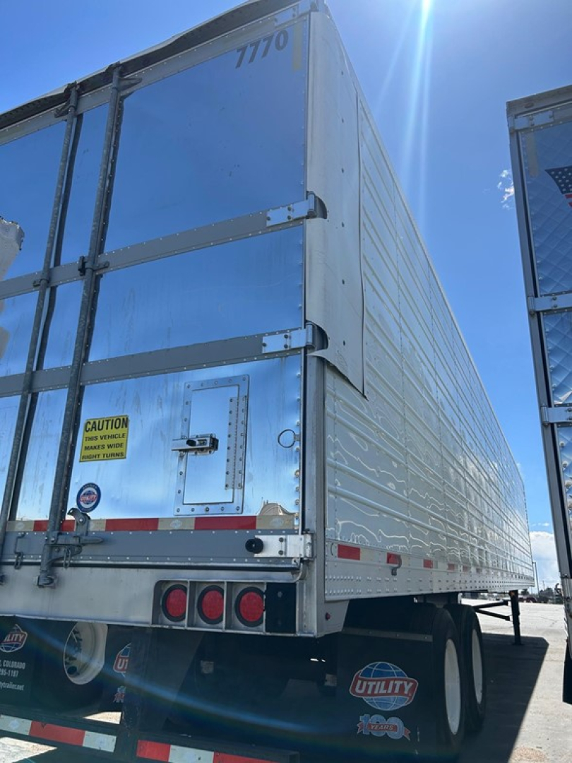Rear view of 2018 Utility 3000R W trailer showing outer aluminum walls, rear doors, taillights, and Utility branding.