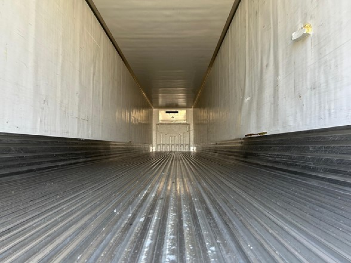 Utility 3000R W trailer interior showing ribbed floor and walls, empty cargo area.