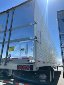 Rear view of 2018 Utility 3000R W trailer showing outer aluminum walls, rear doors, taillights, and Utility branding.