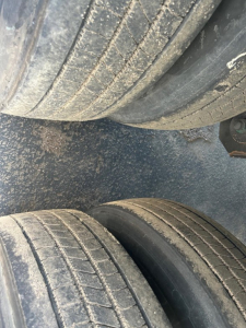 Trailer tires of a 2018 Utility 3000R W trailer showing tread wear and dirt accumulation.