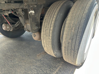 Trailer axle showing dual tires and underside components of a Utility 3000R Reefer trailer wheel area.