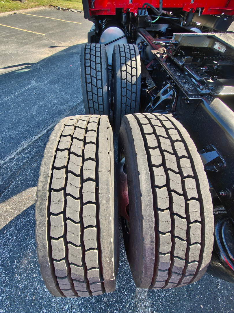 Kenworth truck rear dual rear axles with tires and wheel hubs visible; no legible labels or stickers in view.