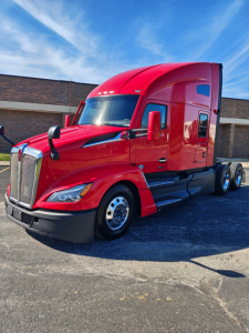 Kenworth T680 2024 red semi-truck in sleeper configuration showing front grille and cab profile.