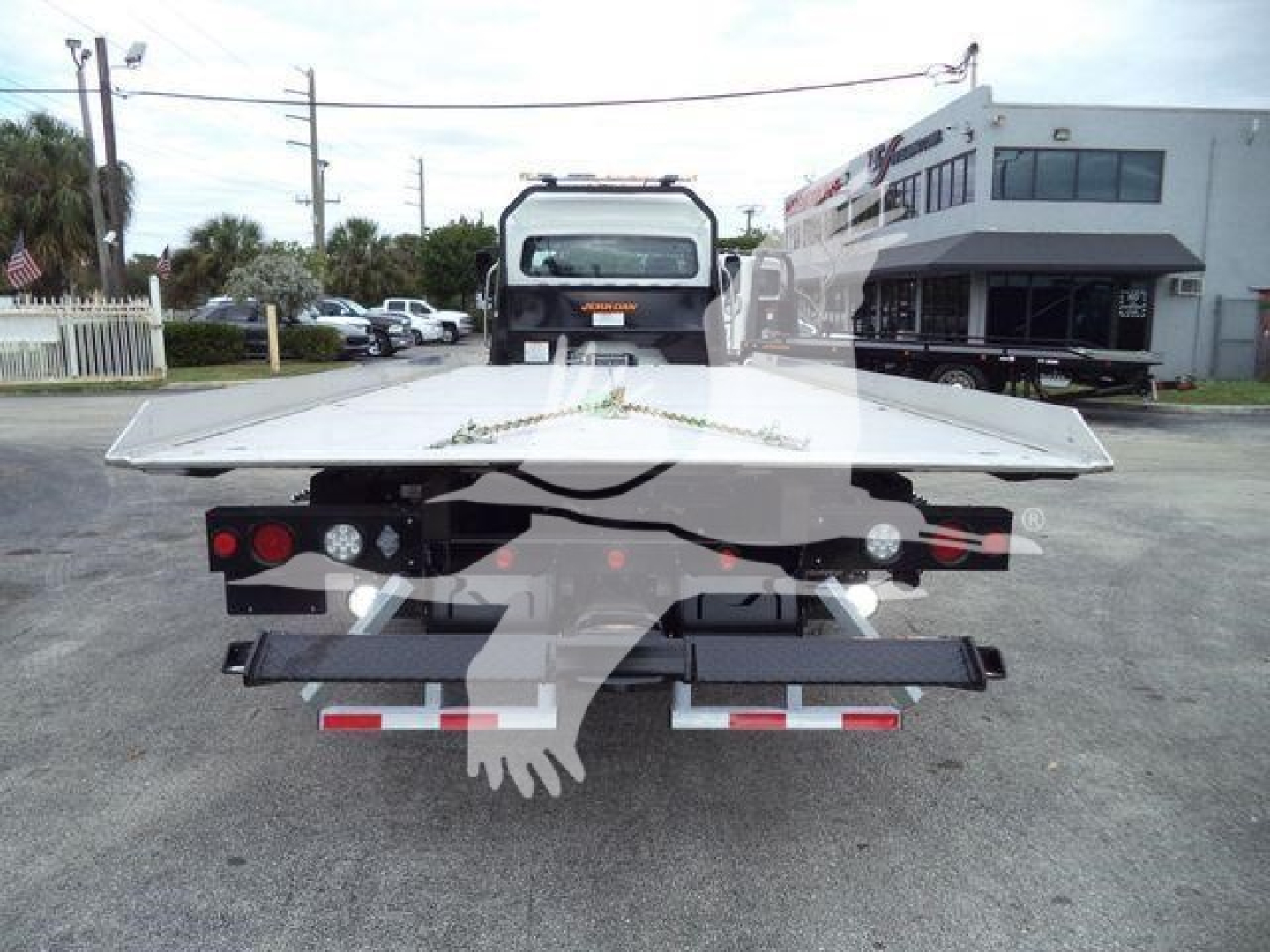 Freightliner M2 106 rollback bed showing flatbed surface and rear lights.