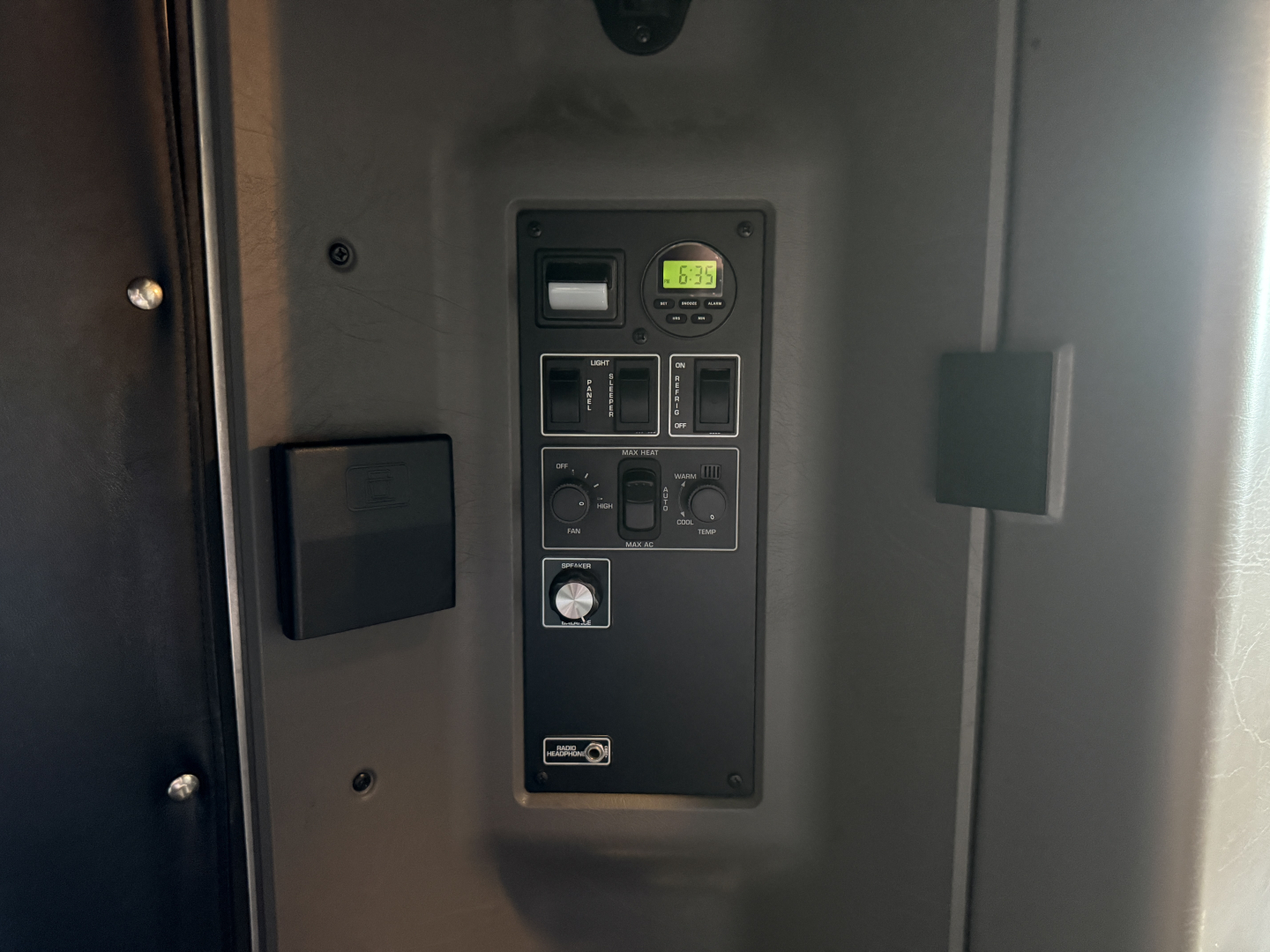 Kenworth W900L dash area with control panel and digital clock visible in sleeper cab doorway