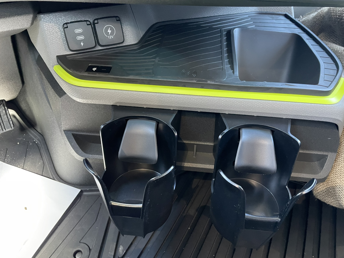 Volvo VNL64T860 interior center console and cup holders with storage tray and green accent trim.