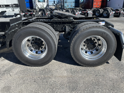 Volvo VNL64T860 tractor axle and dual rear wheels showing chrome rims and black frame with fifth wheel mounting, no cab visible.