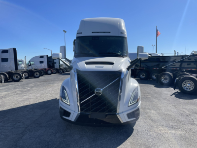 Volvo VNL64T860 semi truck front view showing large grille and headlights in a truck lot.
