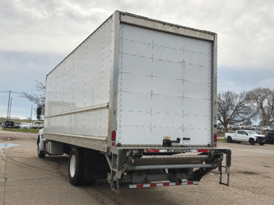 Rear view of a 2020 Hino 268 conventional daycab with a large white box trailer, tail lights, bumper, and mud flaps.