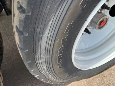 Tire close-up on Smithco air ride side dump trailer showing altrtext 'altrtext' on tire