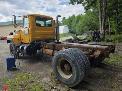Mack RD690P cab and chassis showing front cab, exposed frame rails, dual rear wheels, and side exhaust stack
