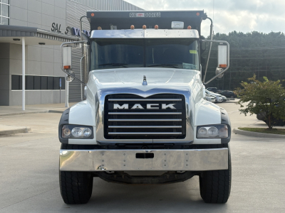 Front view of a 2022 Mack GR64F dump truck showing large chrome bumper, black grille with MACK lettering, dual headlights, and mirrors.