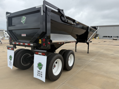 Armor Lite SHD32/48 dump trailer showing dual rear wheels, black hydraulic dump body, safety decals, and mud flaps.