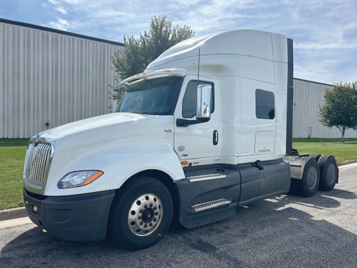 Truck image: 2021 International LT625 conventional sleeper tractor. Visible text: none clearly legible on side; VIN, stock number not on image; general truck features: white cab, black bumper, dual rear axles.