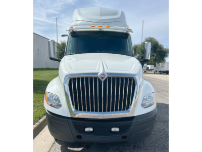International LT625 truck front view showing chrome grille, large bumper, daytime running lights, and elevated cab with aerodynamic roof fairing.