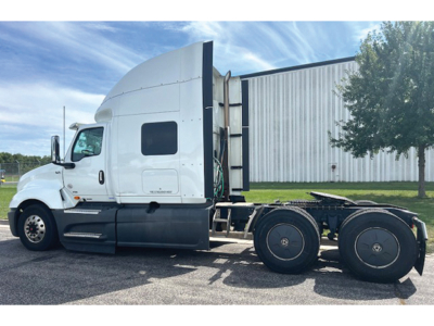 International LT625 truck cab and frame view with sleeper in white, side profile, showing rear wheels and trailer hitch area.