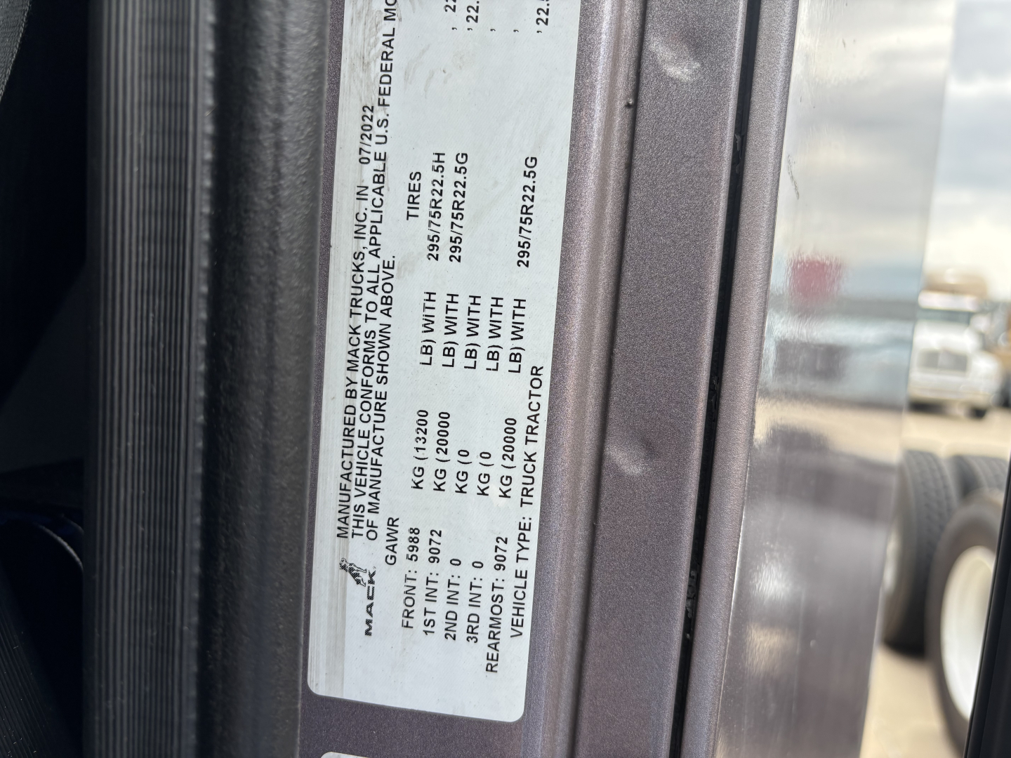 Label on Mack AN64T70 showing vehicle specs including gross axle weights and VIN plate details.