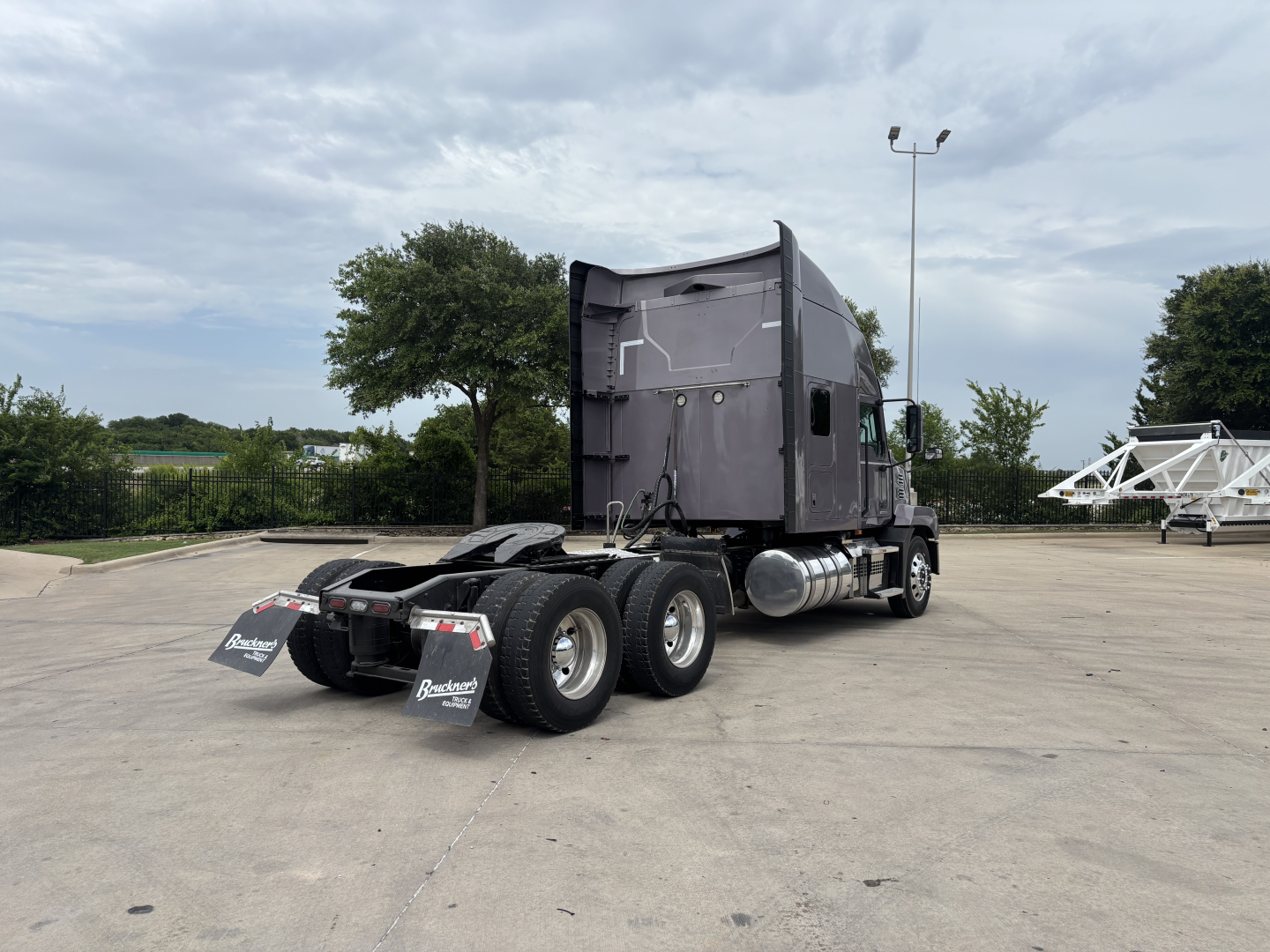 Truck chassis with sleeper cab showing rear wheels and mud flaps, no legible labels visible on image.