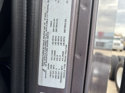 Label on Mack AN64T70 showing vehicle specs including gross axle weights and VIN plate details.