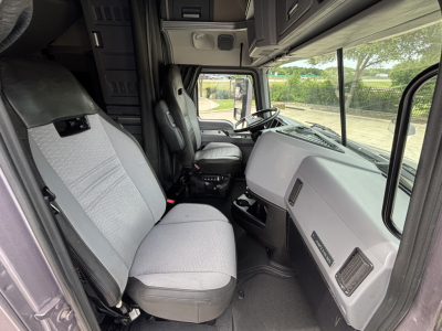 Interior of 2023 Mack AN64T70 sleeper cab showing steering wheel, dashboard, and front seats.