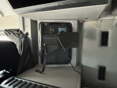Mack AN64T70 interior dash area showing egress panel with wiring harness and mounting bracket.