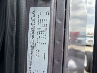 Label on truck door jamb with multiple pressure ratings and fluid specs including PSI values and dual/ single lines.