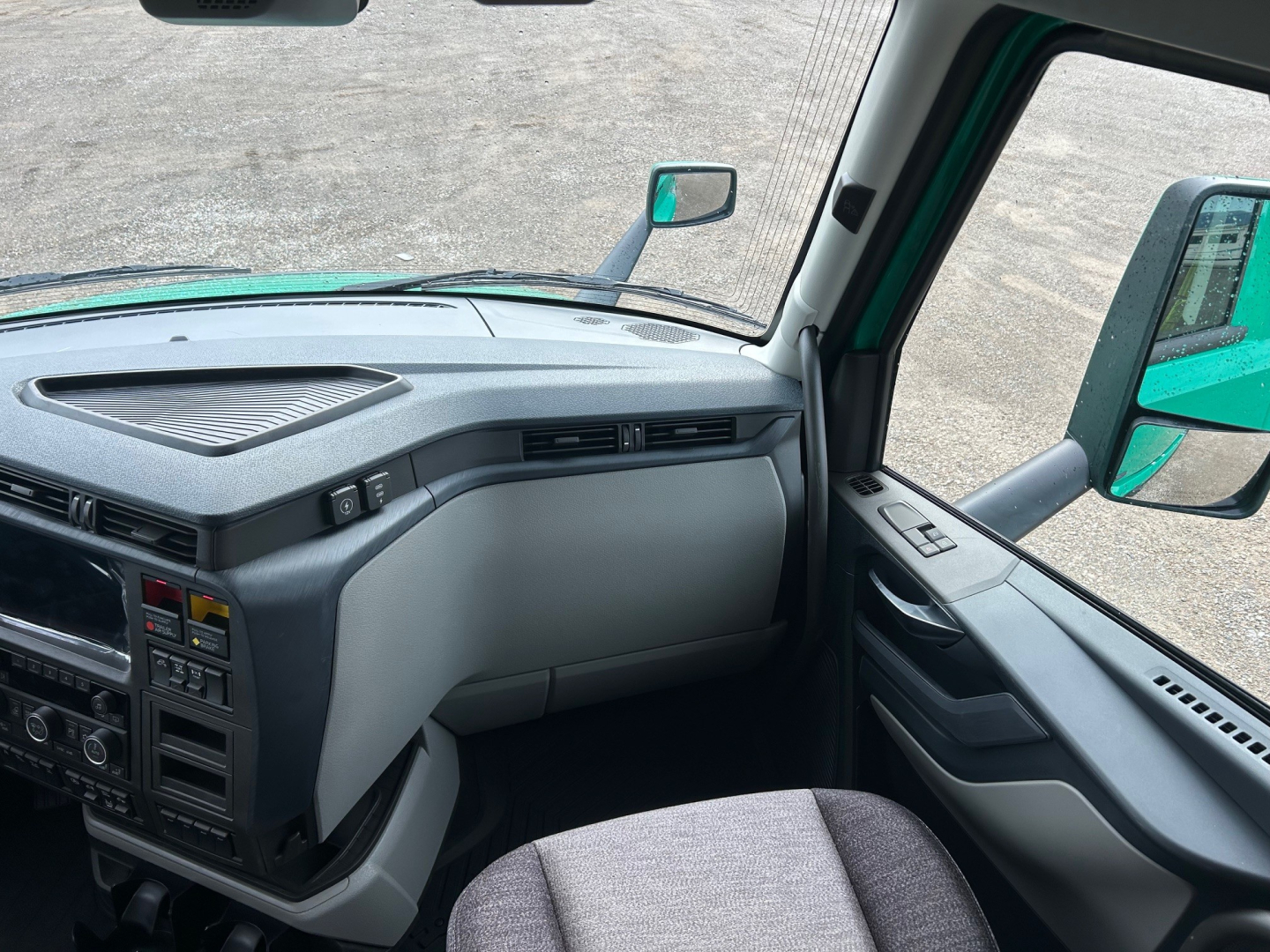 Volvo VNL64T860 cab interior view showing dashboard vents and control panel with steering column area.