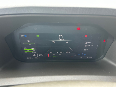 Volvo VNL digital instrument cluster showing 0 mph, various gauges, warning icons, and status indicators in a truck cab.