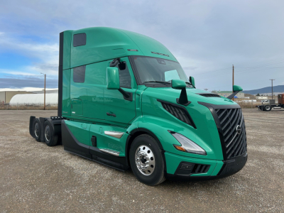 New 2026 Volvo VNL64T860 conventional sleeper truck shown in green, angled front-left view with tractor cab and sleeper, no visible decals.
