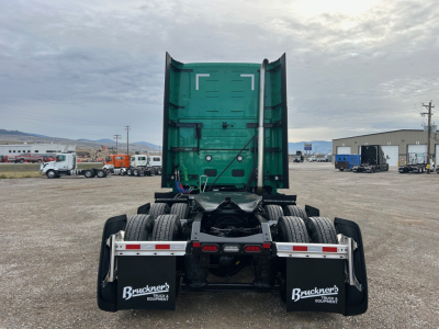 Volvo VNL64T860 tractor rear view showing fifth wheel, dual rear axles, and mud flaps with Buckner's branding.