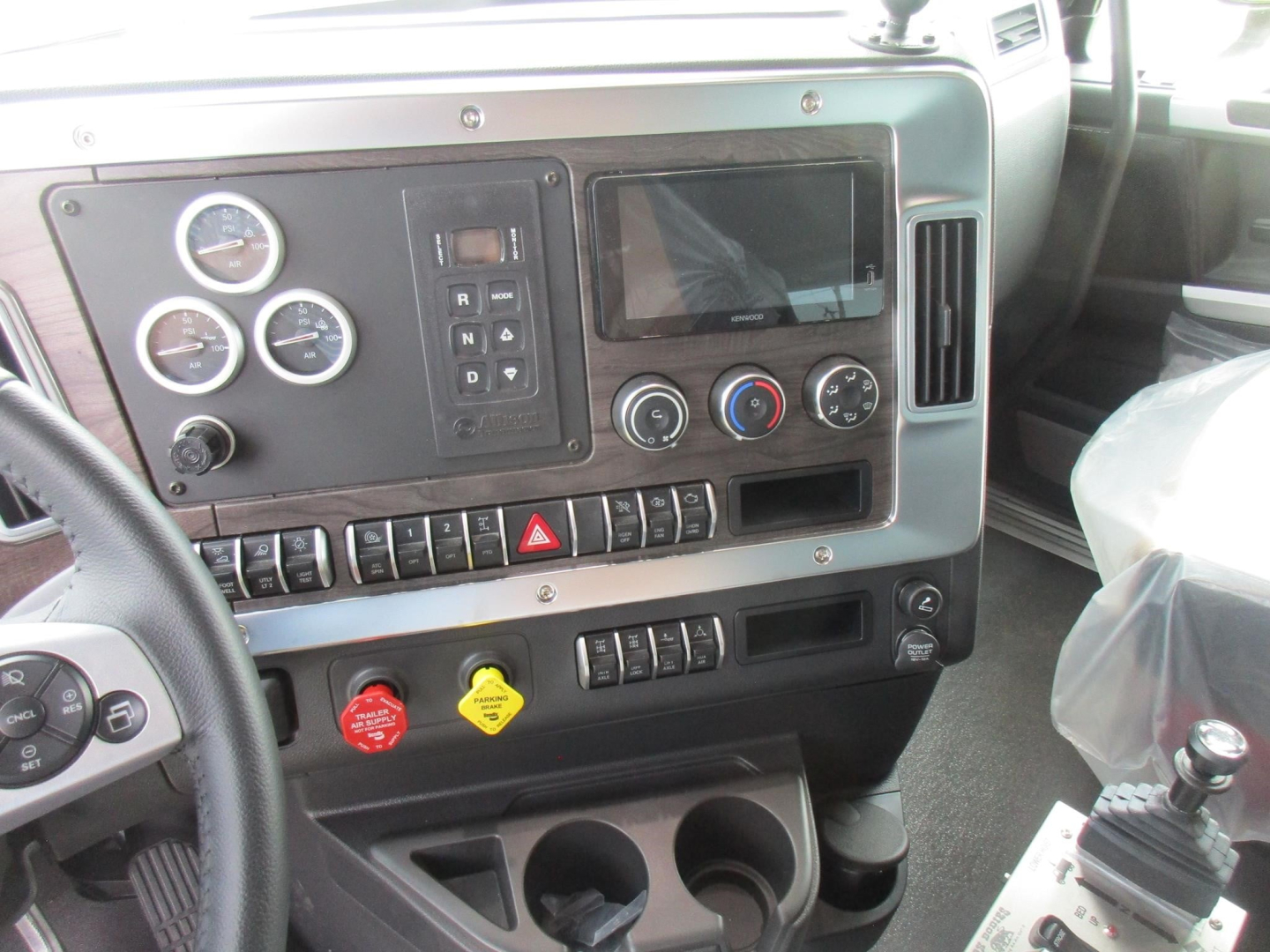 Dashboard of Western Star 49X cabin showing gauges, control panel, climate controls, and gear shifter area.