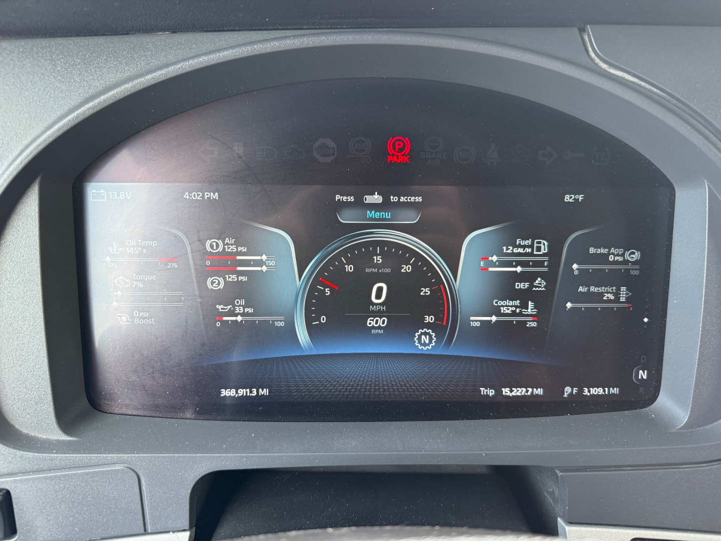 Vehicle dashboard display inside a 2023 Kenworth T680 showing digital gauges including speedometer, fuel, and various vehicle status icons.