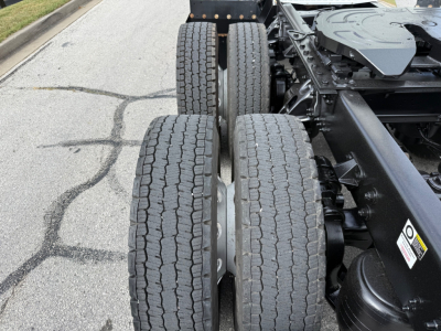 Kenworth T680 chassis with dual rear axles and tires visible in the foreground.