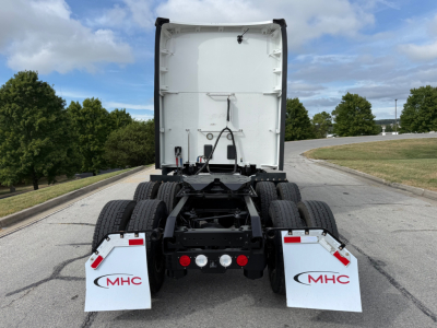 Kenworth T680 tractor rear view showing fifth wheel area and MHC mudflaps with MHC logos.