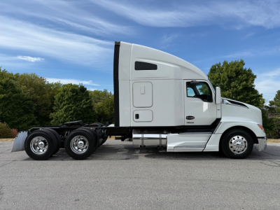 Kenworth T680 tractor in profile showing side view with sleeper cab and dual rear axles.